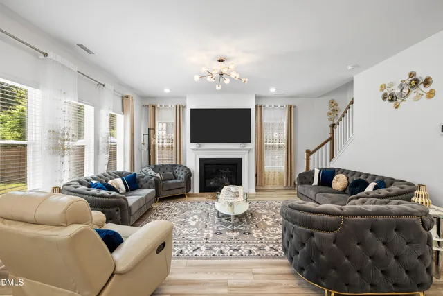 a living room with furniture fireplace and flat screen tv