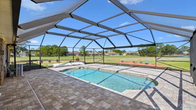 a view of a backyard with swimming pool