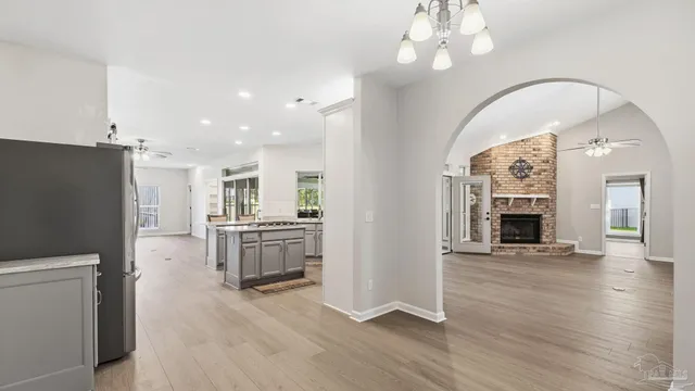 a living room with a fireplace and chandelier