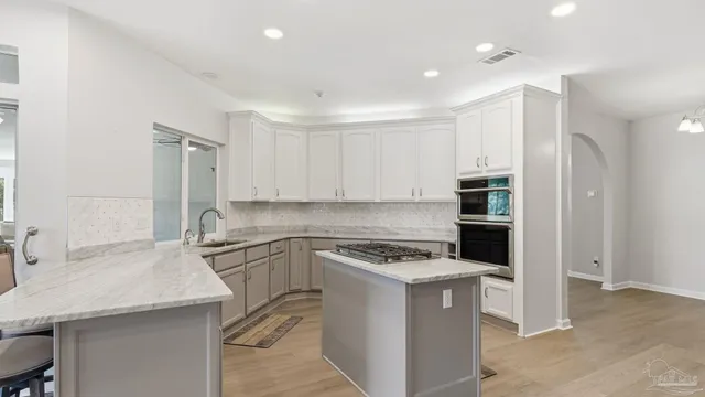 a kitchen with a sink stove and refrigerator