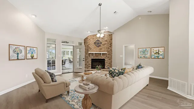 a living room with furniture a fireplace and a chandelier