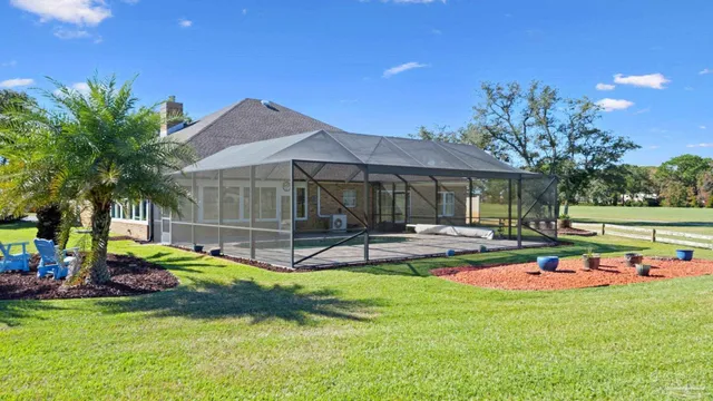 a view of a house with backyard and sitting area