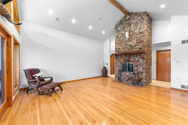 a living room with furniture floor to ceiling window and wooden floor