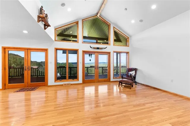 a large open kitchen with a large window and stainless steel appliances