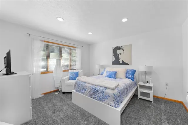 a bathroom with a bathtub sink and mirror