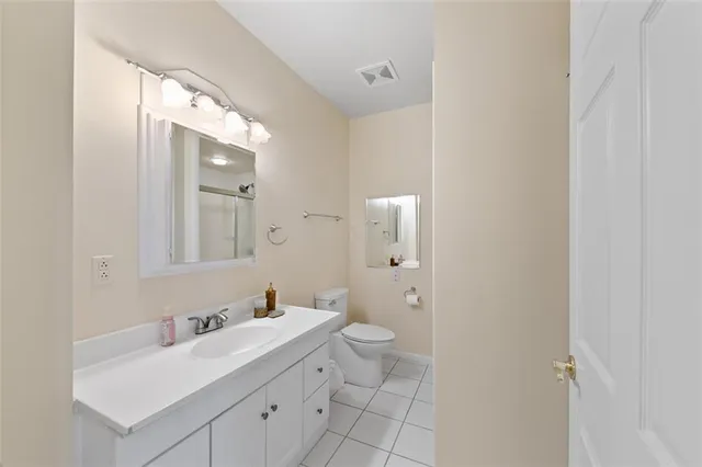 a bathroom with a sink a toilet and a shower