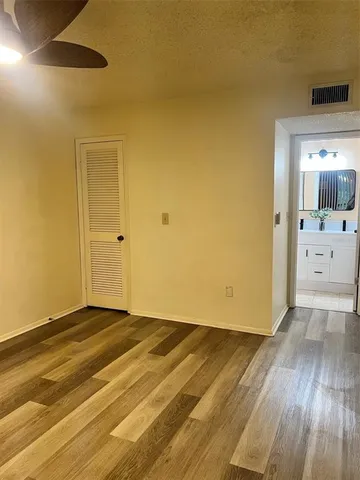 a view of a room with wooden floor and cabinet