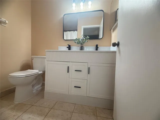 a bathroom with a sink toilet and mirror