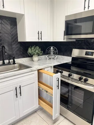 a kitchen with stainless steel appliances granite countertop a stove and a sink