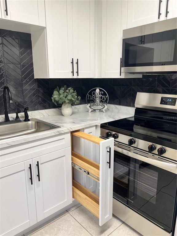 11707 Raintree Village Boulevard, Unit C Temple Terrace, FL 33617 - Photo 6 of 31 a kitchen with stainless steel appliances granite countertop a stove and a sink