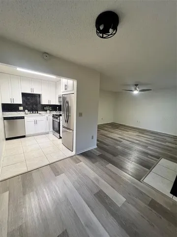 a kitchen with a refrigerator and a stove top oven