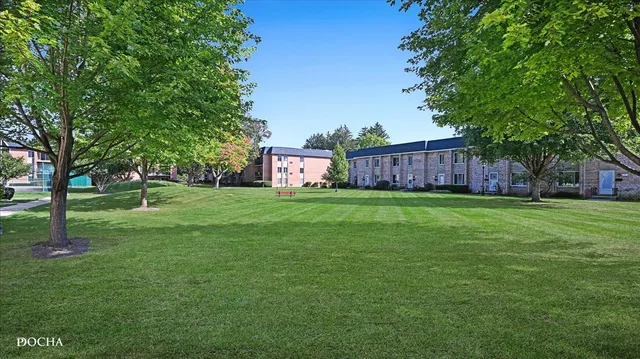 a view of a garden with a house in the background