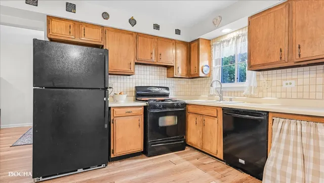 a kitchen with stainless steel appliances granite countertop a refrigerator stove and sink