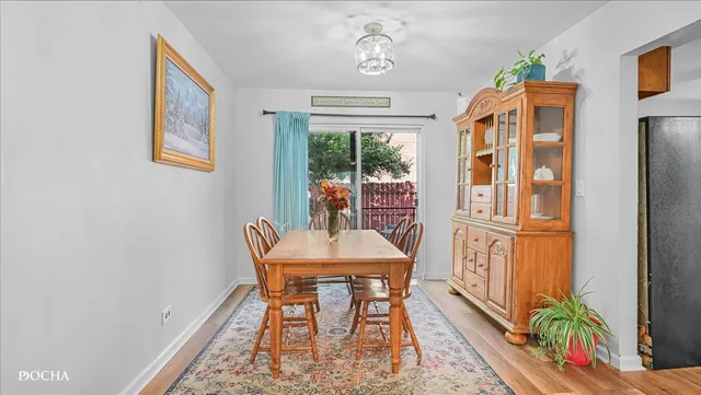 a dining room with furniture a flat screen tv and a floor to ceiling window