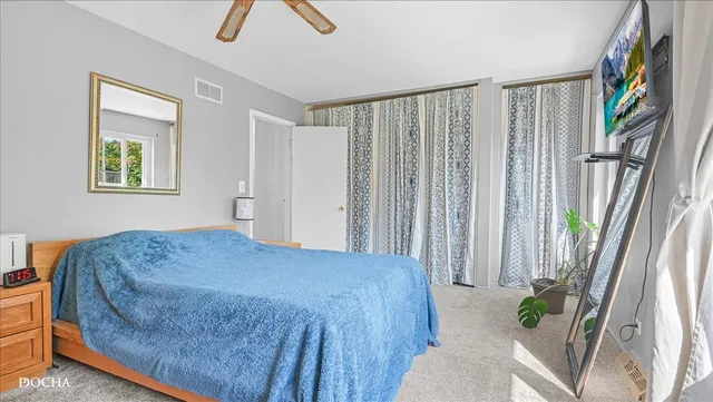 a bedroom with a bed and a painting on the wall