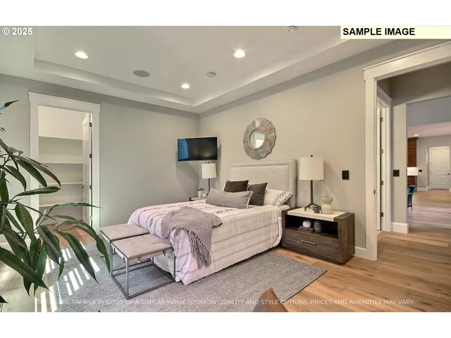 a living room with a bed furniture and a flat screen tv