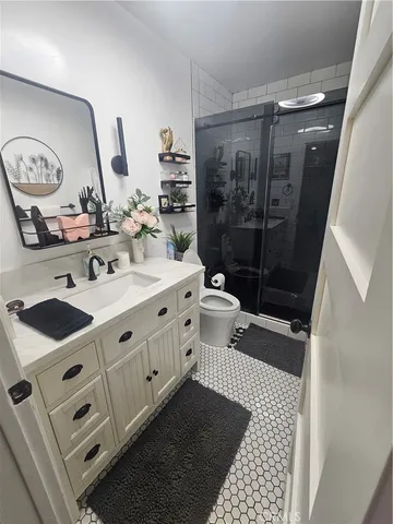 a bathroom with a toilet a sink and mirror