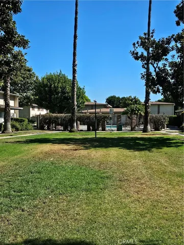 a view of a brick house with many windows