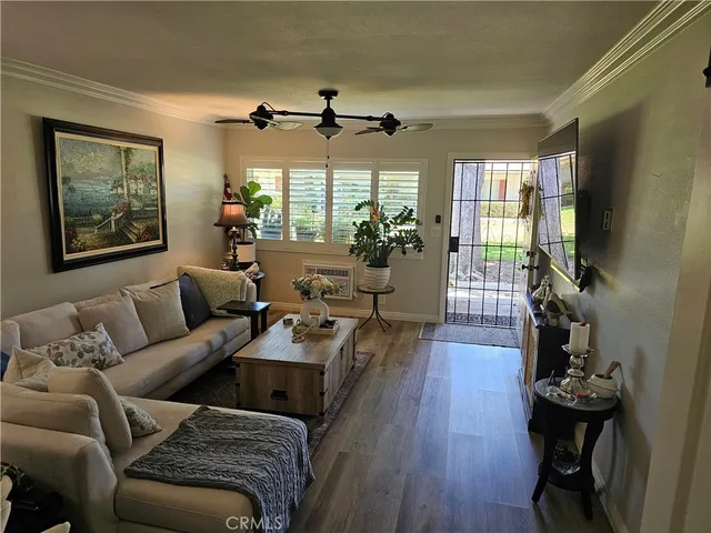 a view of living room with furniture and wooden floor