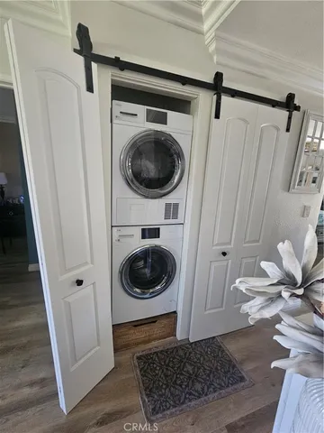 a kitchen with stainless steel appliances a dining table chairs and stove
