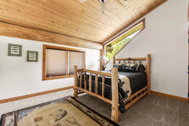 a bed sitting in a bedroom next to a window