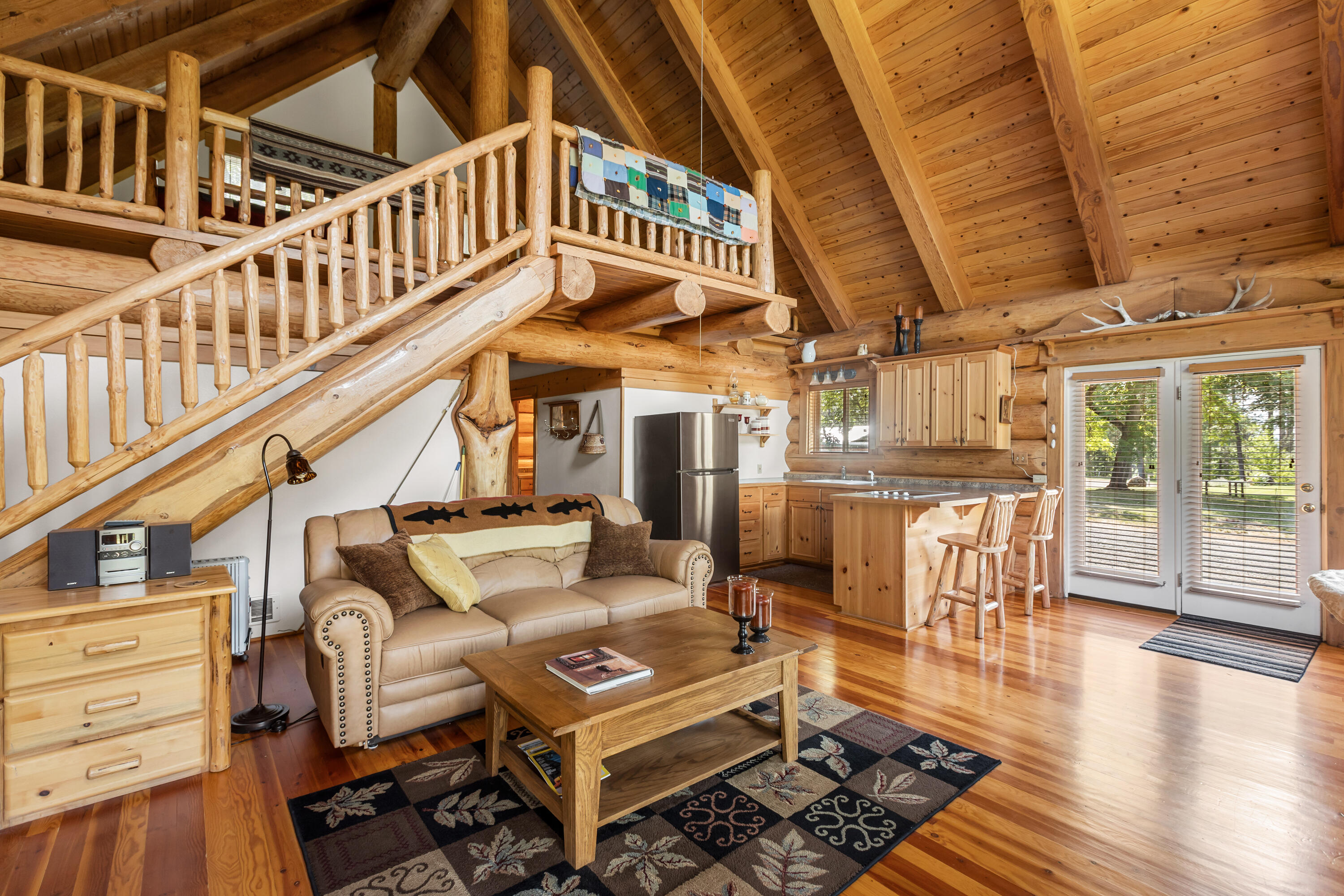 0 Summit Lake Road Montgomery Creek, CA 96065 - Photo 24 of 41 a view of a patio with couches table and chairs with wooden floor