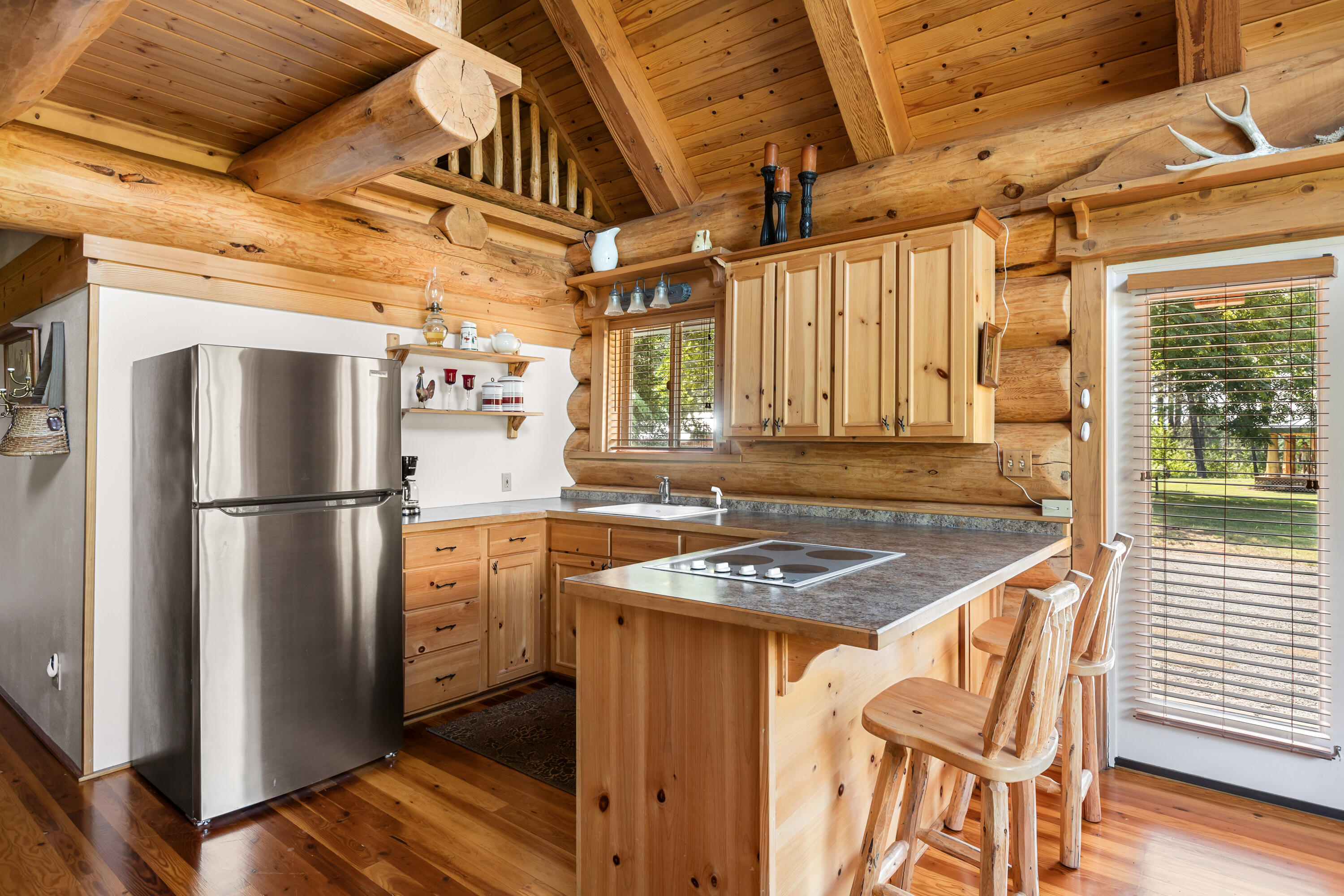 0 Summit Lake Road Montgomery Creek, CA 96065 - Photo 25 of 41 a kitchen with stainless steel appliances granite countertop a refrigerator a sink dishwasher a stove and a dining table with wooden floor