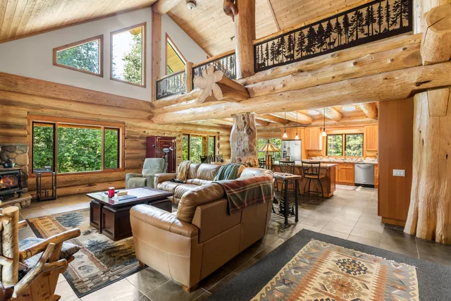 a living room with furniture fireplace and a large window
