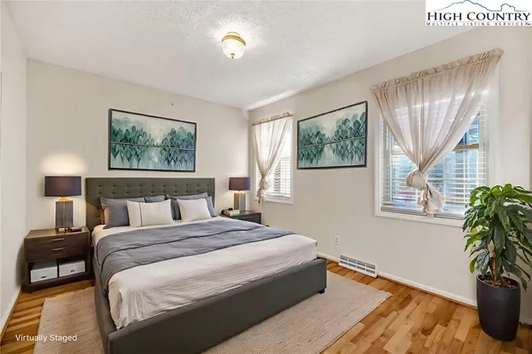 a bedroom with a bed and a potted plant