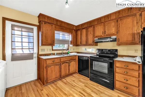 a kitchen with stainless steel appliances granite countertop a stove and a sink