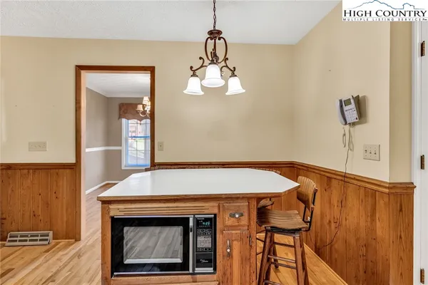 a room with a table and a fireplace