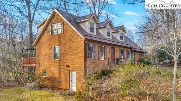 a view of a brick house with a yard