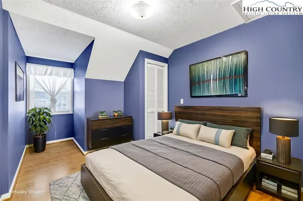 a bedroom with a bed and a dresser