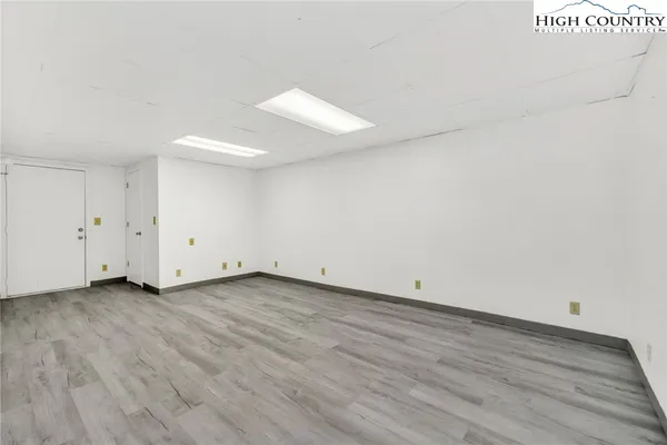 a view of a room with wooden floor