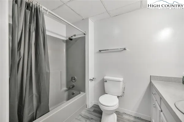 a bathroom with a granite countertop toilet a sink and bathtub