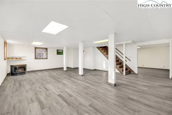 a view of a livingroom with wooden floor and stairs