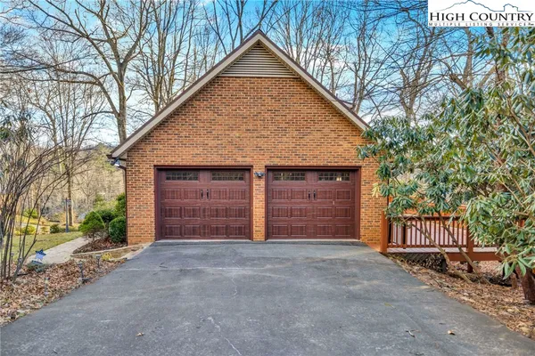 a view of a house with a yard and garage