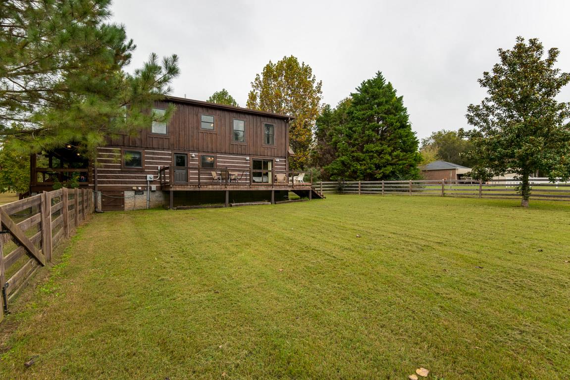 703 Beckwith Road Mount Juliet, TN 37122 - Photo 27 of 29 a view of a swimming pool with lawn chairs under an umbrella
