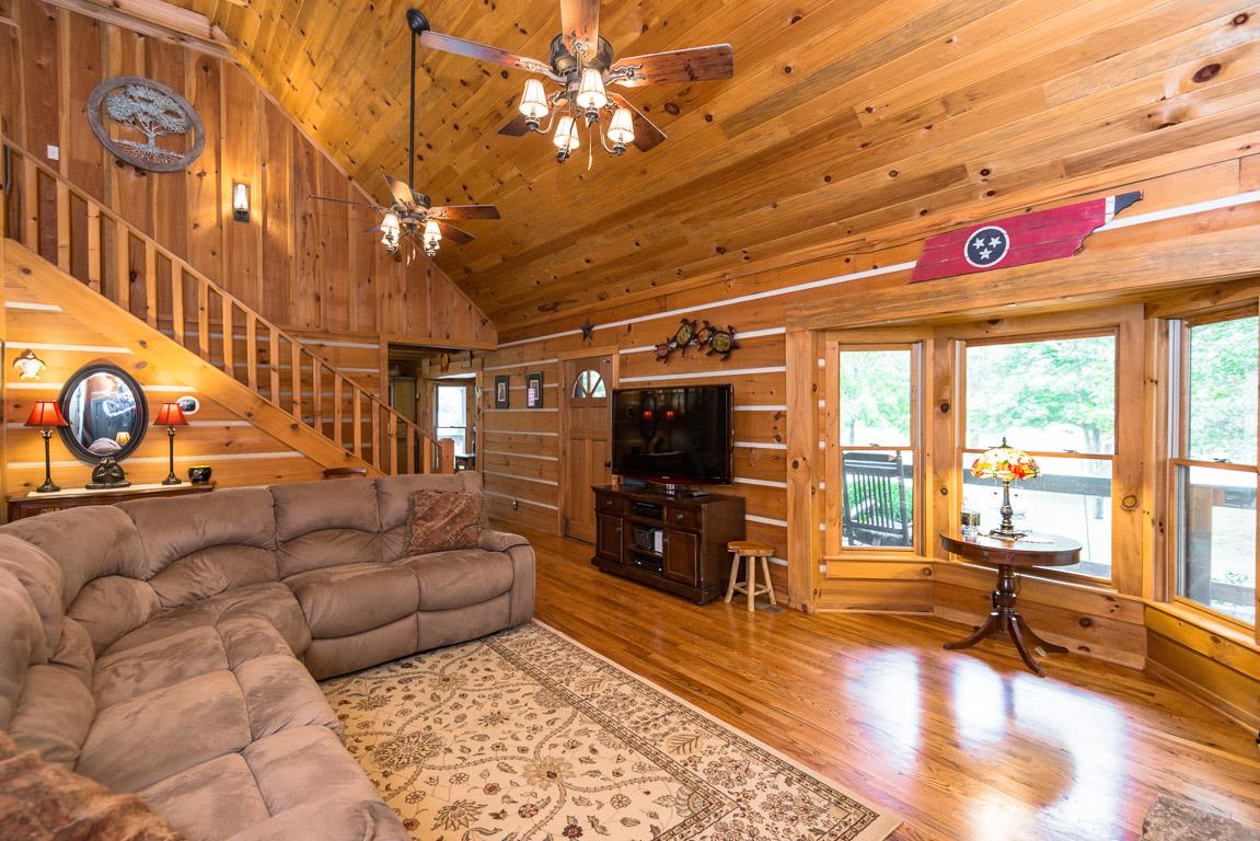 703 Beckwith Road Mount Juliet, TN 37122 - Photo 5 of 29 a living room with furniture a flat screen tv and floor to ceiling window