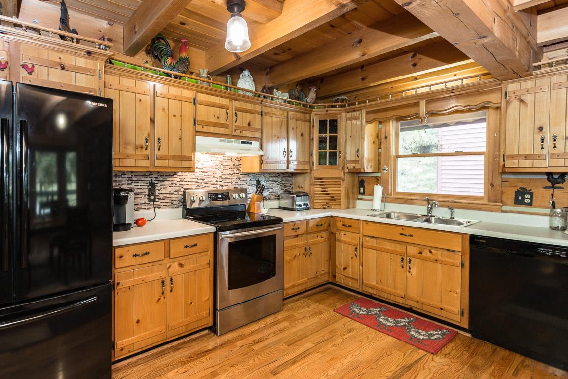 703 Beckwith Road Mount Juliet, TN 37122 - Photo 8 of 29 a kitchen with stainless steel appliances granite countertop a sink cabinets and wooden floor