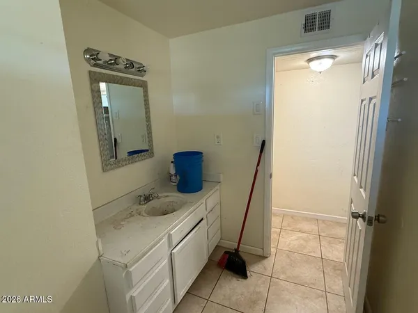 a bathroom with a sink a toilet and mirror