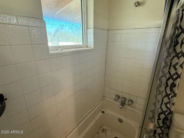 a bathroom with a bathtub and shower