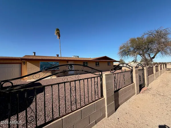 a front view of a house with wooden fence