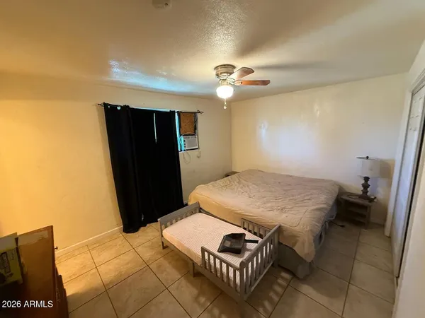 a bedroom with a bed and a table