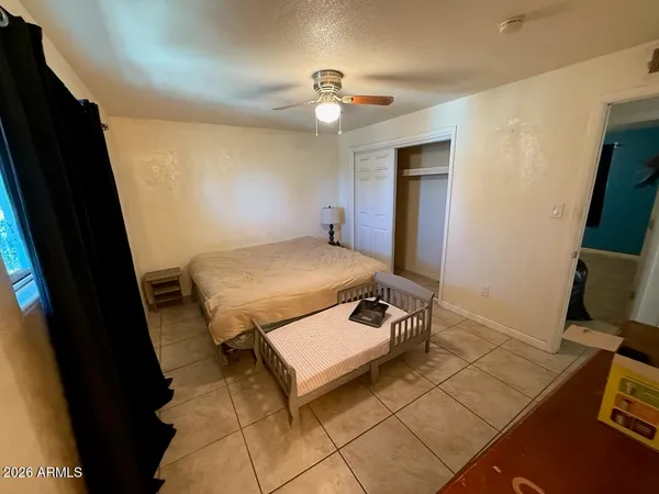 a living room with a bed furniture and a flat screen tv