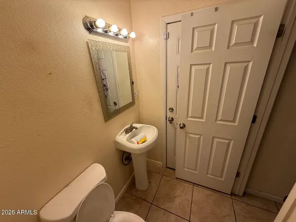a bathroom with a sink toilet and mirror