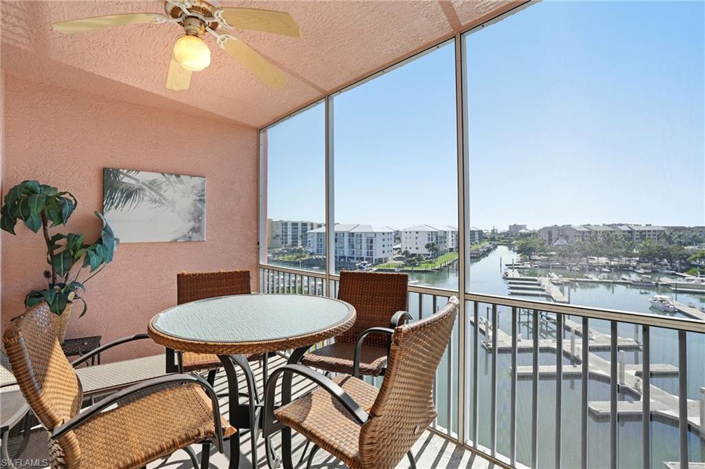 150 Lenell Road, Unit 503 Fort Myers Beach, FL 33931 - Photo 11 of 32 a balcony with table and chairs