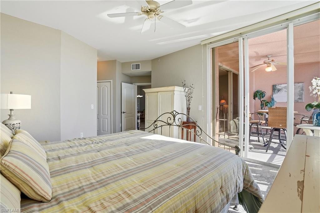 150 Lenell Road, Unit 503 Fort Myers Beach, FL 33931 - Photo 25 of 32 a bedroom with a bed and a chandelier