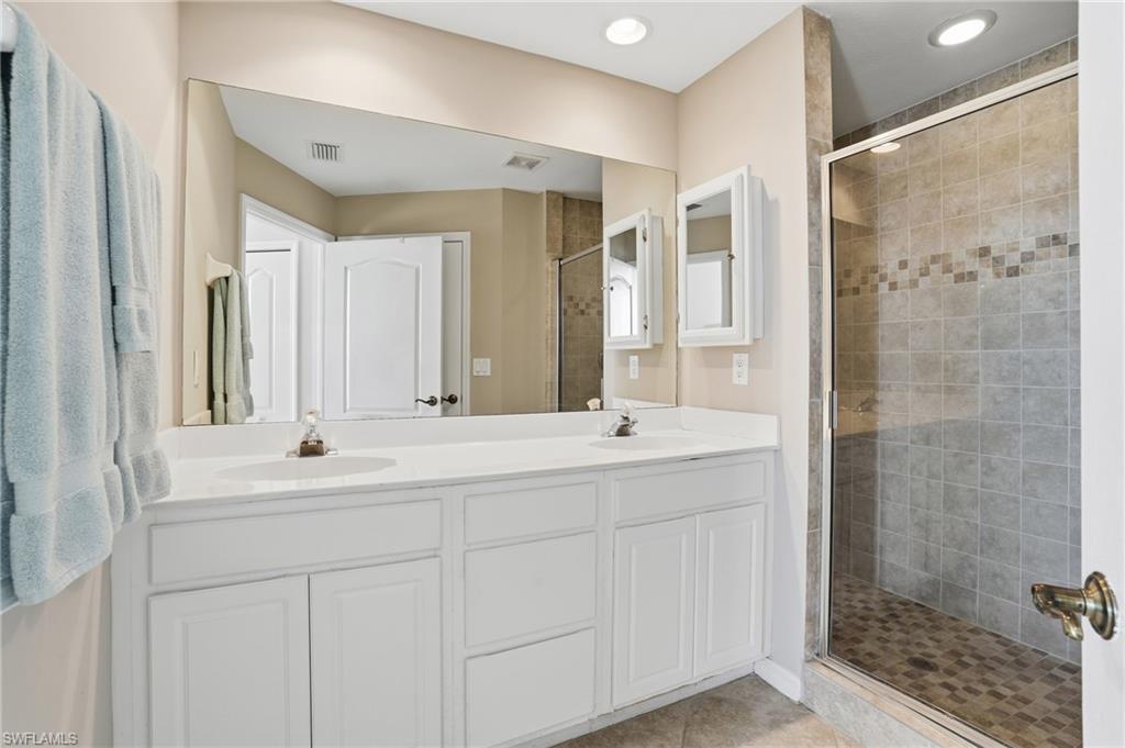 150 Lenell Road, Unit 503 Fort Myers Beach, FL 33931 - Photo 26 of 32 a bathroom with a double vanity sink mirror and shower