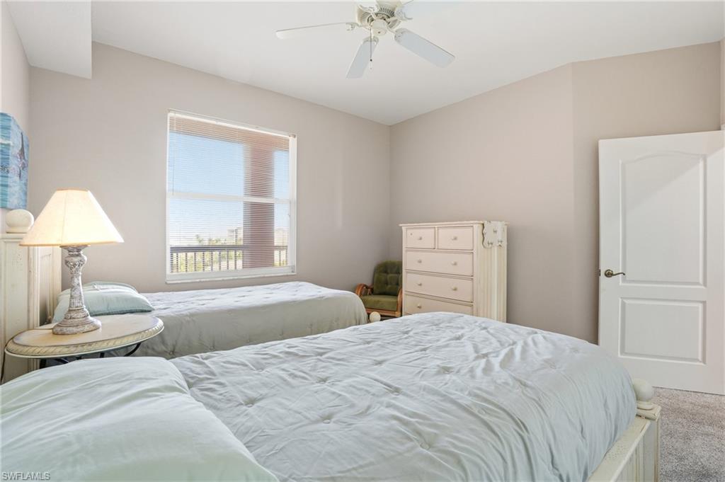 150 Lenell Road, Unit 503 Fort Myers Beach, FL 33931 - Photo 30 of 32 a bedroom with a bed and a lamp